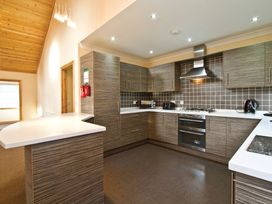 A kitchen with various appliances and cabinets at Osprey Spa Plus in Dundee