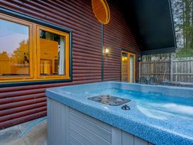 A hot tub on an outdoor patio at Osprey Spa Plus (Pet) in Dundee