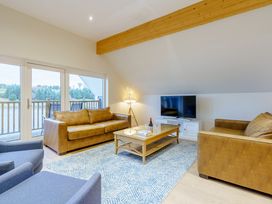 A living room with sofas and a television at Lochside Premier Spa in Dundee