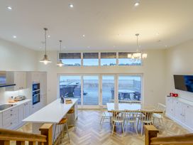 A kitchen with a dining area and large windows at Lochside Premier Spa in Dundee