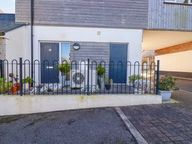An outdoor space with a fence, door, plants, and an air conditioning unit at 33 Fordh Tobmen St. Agnes