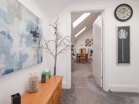 A hallway with wall art, a tree decoration, and a console table at 33 Fordh Tobmen in St. Agnes