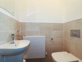 A bathroom with a sink, toilet, and radiator at 33 Fordh Tobmen in St. Agnes