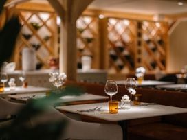 A dining room with tables and wine glasses at Garden Pod VIP in Waltham