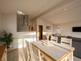 A dining room with a table and chairs at Belfry Waltham