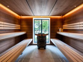A sauna with wooden benches and a window at Belfry in Waltham