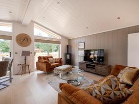 A living room with a television and sofa at Moonlight Spa Luxury in Waltham