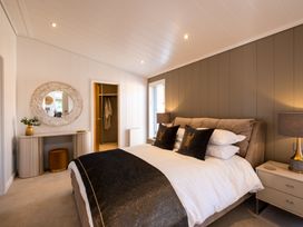 A bedroom with a bed and dresser at Moonlight Spa Luxury in Waltham