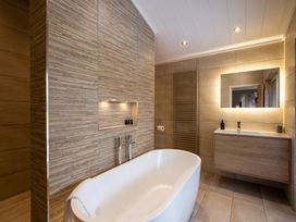 A bathroom with a bathtub and sink at Moonlight Spa Luxury in Waltham