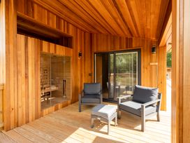 An outdoor seating area with chairs and a sauna at Moonlight Spa Luxury in Waltham