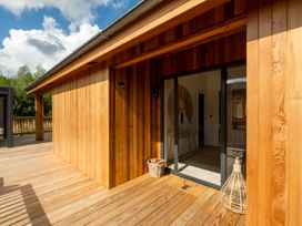 An outdoor patio with wooden walls and a glass door at Moonlight Spa Luxury Waltham