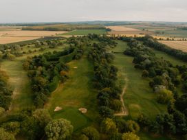 An aerial view of a golf course surrounded by greenery at Moonlight Spa Luxury in Waltham