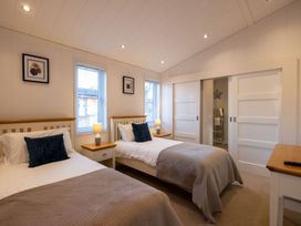 A bedroom with two beds and windows at Wentworth in Waltham