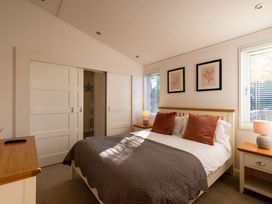 A bedroom with a bed and nightstands at Wentworth in Waltham