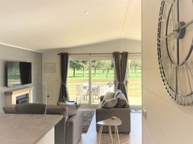 A living room with a television and sofa at Dream View in Waltham