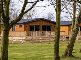 A wooden cabin with a deck at Royal View in Waltham