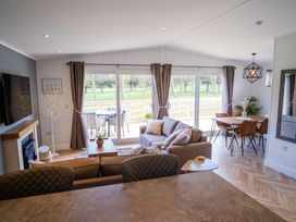 A living room with a sofa and dining area at Royal View in Waltham