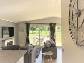 A living room with a sofa and television at Royal View in Waltham