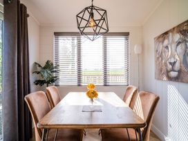 A dining room with a table and chairs at Goldfinch in Waltham