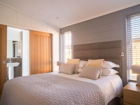 A bedroom with a bed and bedside table at Goldfinch in Waltham