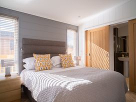 A bedroom with a bed and lamps at Goldfinch in Waltham