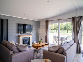 A living room with a television and coffee table at Imperial View in Waltham