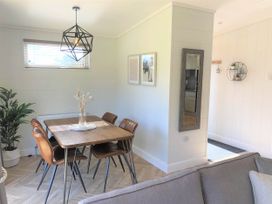 A dining room with a table and chairs at Imperial View in Waltham