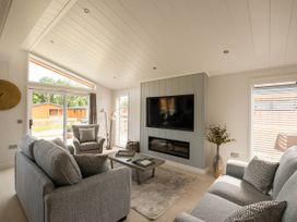 A living room with a sofa and television at The Luxury Hideaway in Waltham