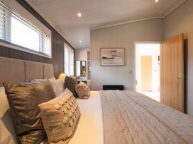 A bedroom with a bed and pillows at The Luxury Hideaway in Waltham