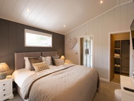 A bedroom with a bed and a nightstand at The Luxury Hideaway in Waltham