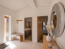 An entrance hall with a table and mirror at The Luxury Hideaway in Waltham