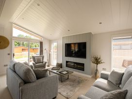 A living room with a sofa and armchair at The Luxury Hideaway in Waltham