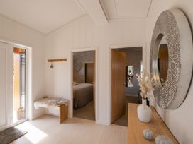 A hallway with a mirror and table at The Luxury Hideaway in Waltham