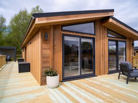 A wooden exterior with large windows and decking at The Luxury Hideaway in Waltham