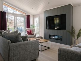A living room with a television and sofa at The Luxury Hideaway in Waltham