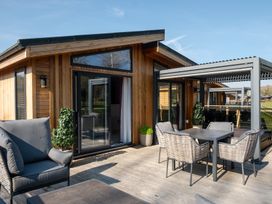 An outdoor area with a table and chairs at The Luxury Hideaway in Waltham