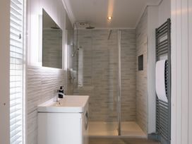 A bathroom with a shower and washbasin at The Luxury Hideaway in Waltham
