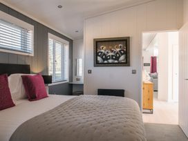 A bedroom with a bed and wall art at The Luxury Hideaway in Waltham