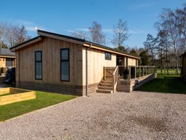 A wooden cabin with a deck and steps at The Luxury Hideaway in Waltham
