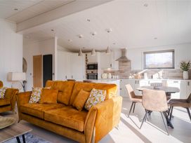 A living room with a sofa and dining area at Luxurious Serenity in Waltham