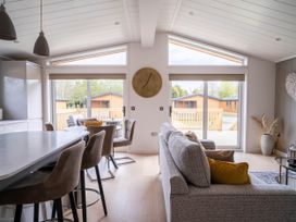A living room with a sofa and dining area at The Luxury Escape in Waltham