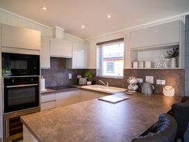 A kitchen with appliances and a countertop at Dovecote in Waltham