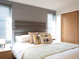 A bedroom with a bed and decorative pillows at Dovecote in Waltham