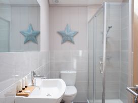 A bathroom featuring a sink, toilet, and shower at The Henley in Waltham