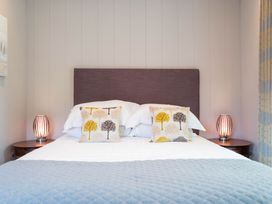 A bedroom with a bed and decorative pillows at The Henley in Waltham