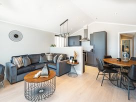 A living room with a sofa and dining area at Shangri-La in Waltham