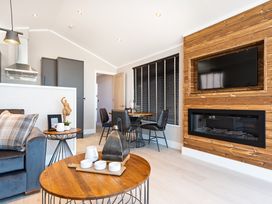 A living room with a sofa and television at Shangri-La in Waltham