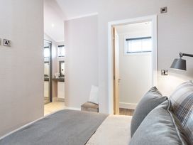 A bedroom with a bed and a mirror at Shangri-La in Waltham