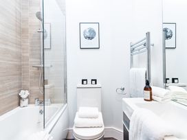 A bathroom with a bathtub, shower, and toilet at Shangri-La in Waltham