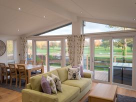 A living room with a sofa and dining area at The Royal in Waltham